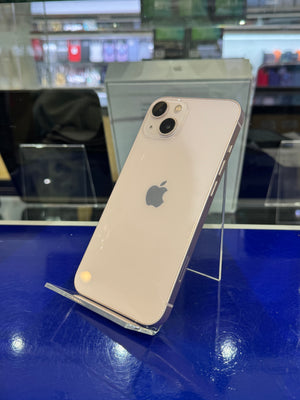 Silver iPhone 11 on a blue surface with blurred background