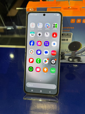 Smartphone with app icons displayed on a blue surface