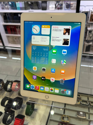 Tablet device with a colorful display of app icons on a glass surface