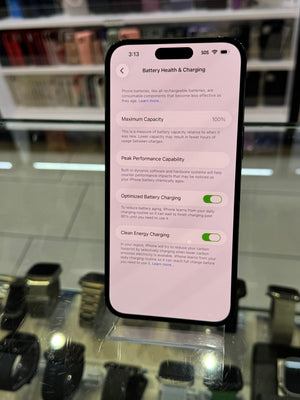 Smartphone displaying battery health and charging settings on a blurred background
