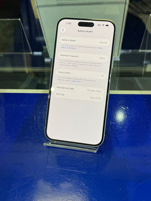 Smartphone displaying battery health information on a reflective blue surface