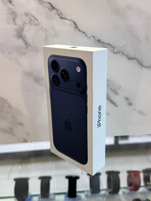 A boxed Apple iPhone shown upright in its retail packaging, with the back of the phone visible through a large cutout on the box. The box is white with a dark blue phone image and the word 'iPhone' printed on the side.