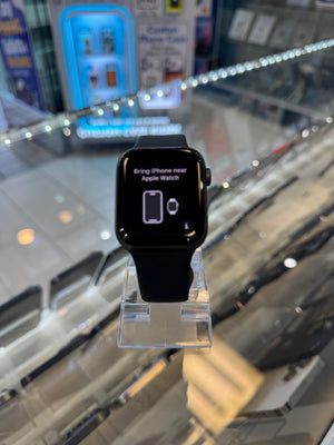 Black Apple Watch on display in a store with a blurred background