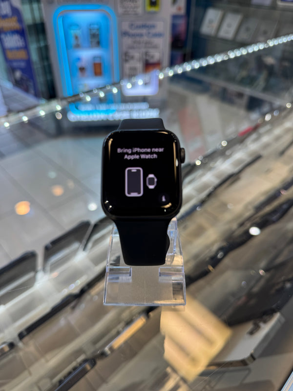 Black Apple Watch on display in a store with a blurred background