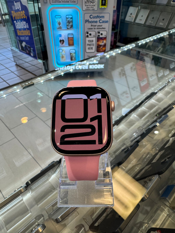 Smartwatch with pink band on a clear stand in a store setting