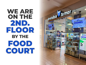 Storefront with 'Invisible Armor' branding and promotional text for a second-floor location.